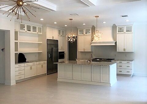 white kitchen center island gold lighting and accents