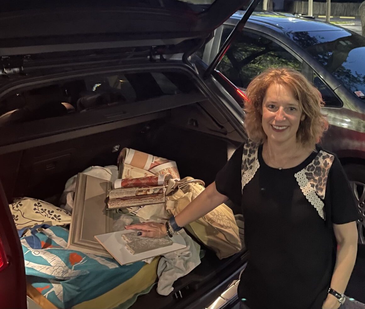 Johanna at her car with interior design samples and plans