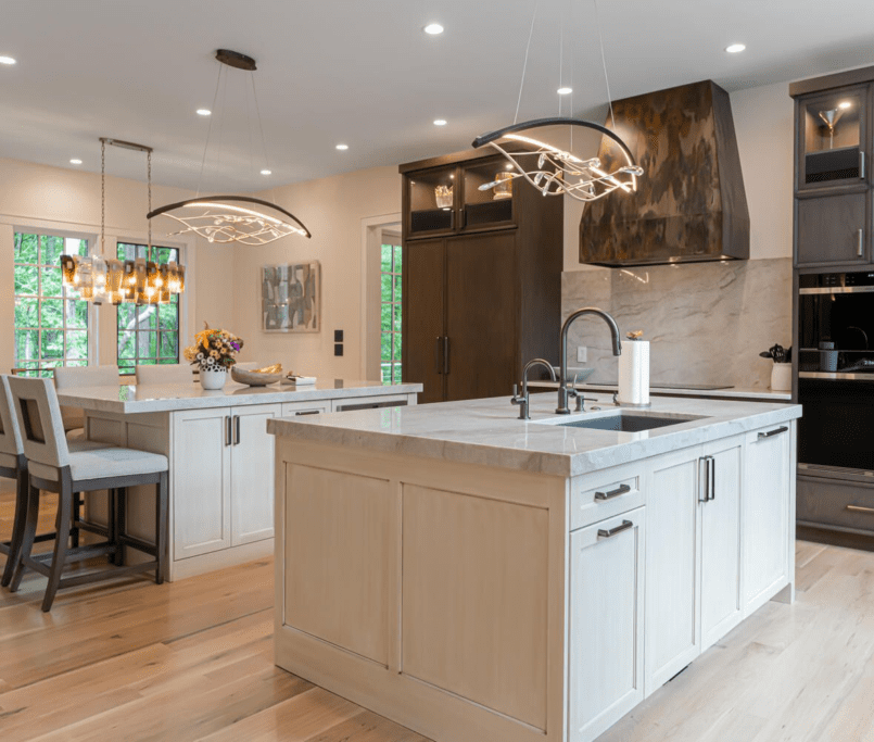 luxury kitchen with double island with natural stone countertops, bespoke pendant lighting